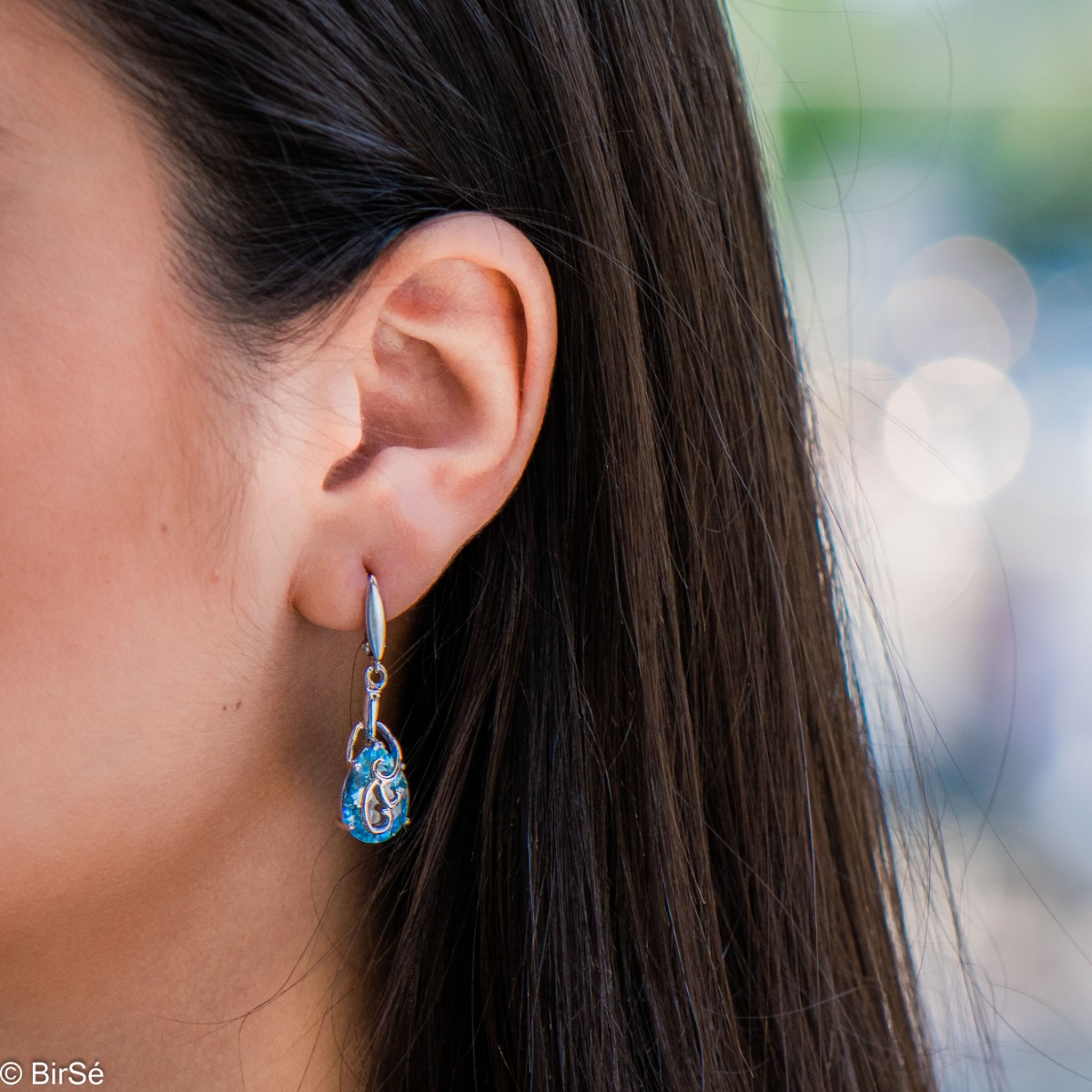 Exclusive pendant earrings with English clasp and exquisite workmanship combining a radiant natural blue topaz in a delicate teardrop shape with shiny rhodium silver. Can be combined with a pendant and a ring of the same model.