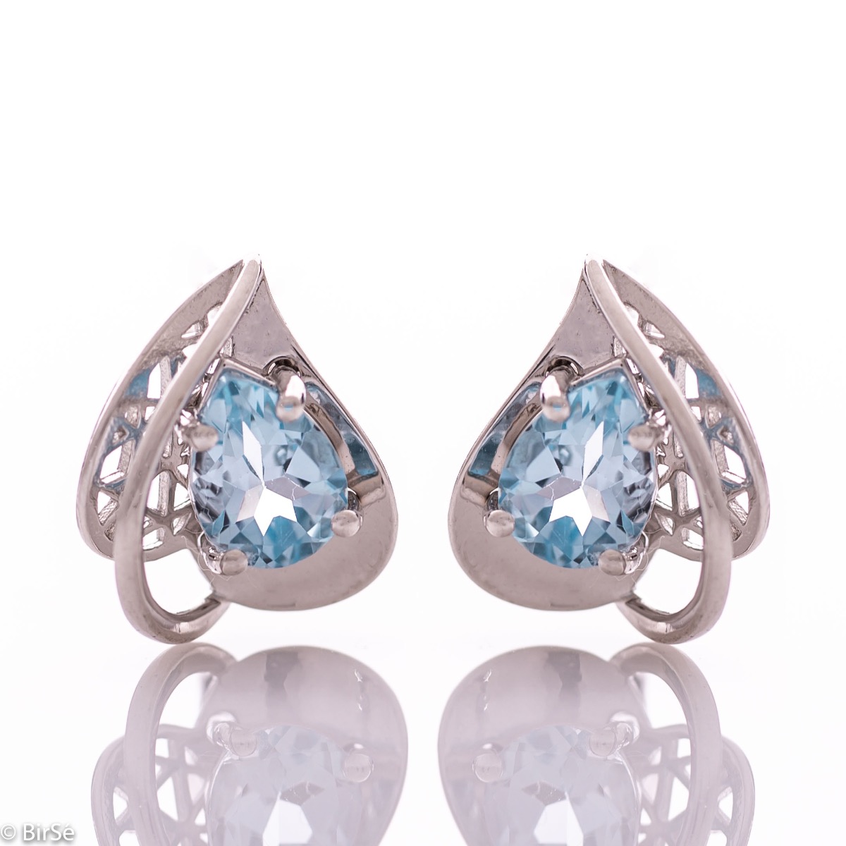 Spectacular ladies' earrings with English clasp and delicate heart-like shape, combined with radiant natural blue topaz and rhodium-plated silver. It can be combined with a pendant and a ring of the same model.