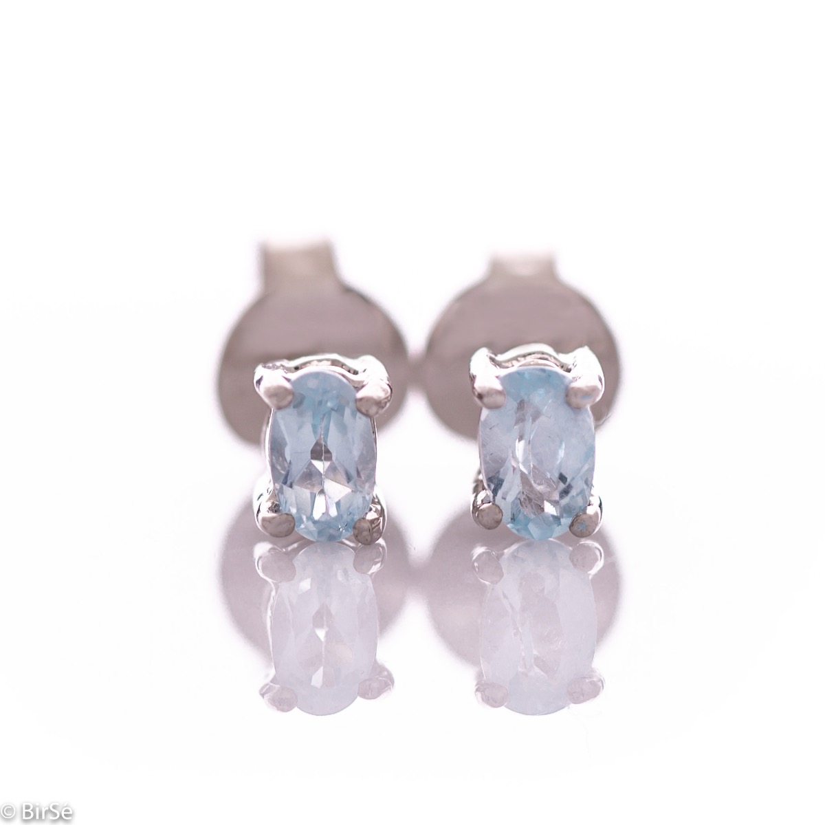 Spectacular and glamorous natural blue topaz complemented by delicate rhodium silver - our new offer silver stud earrings.