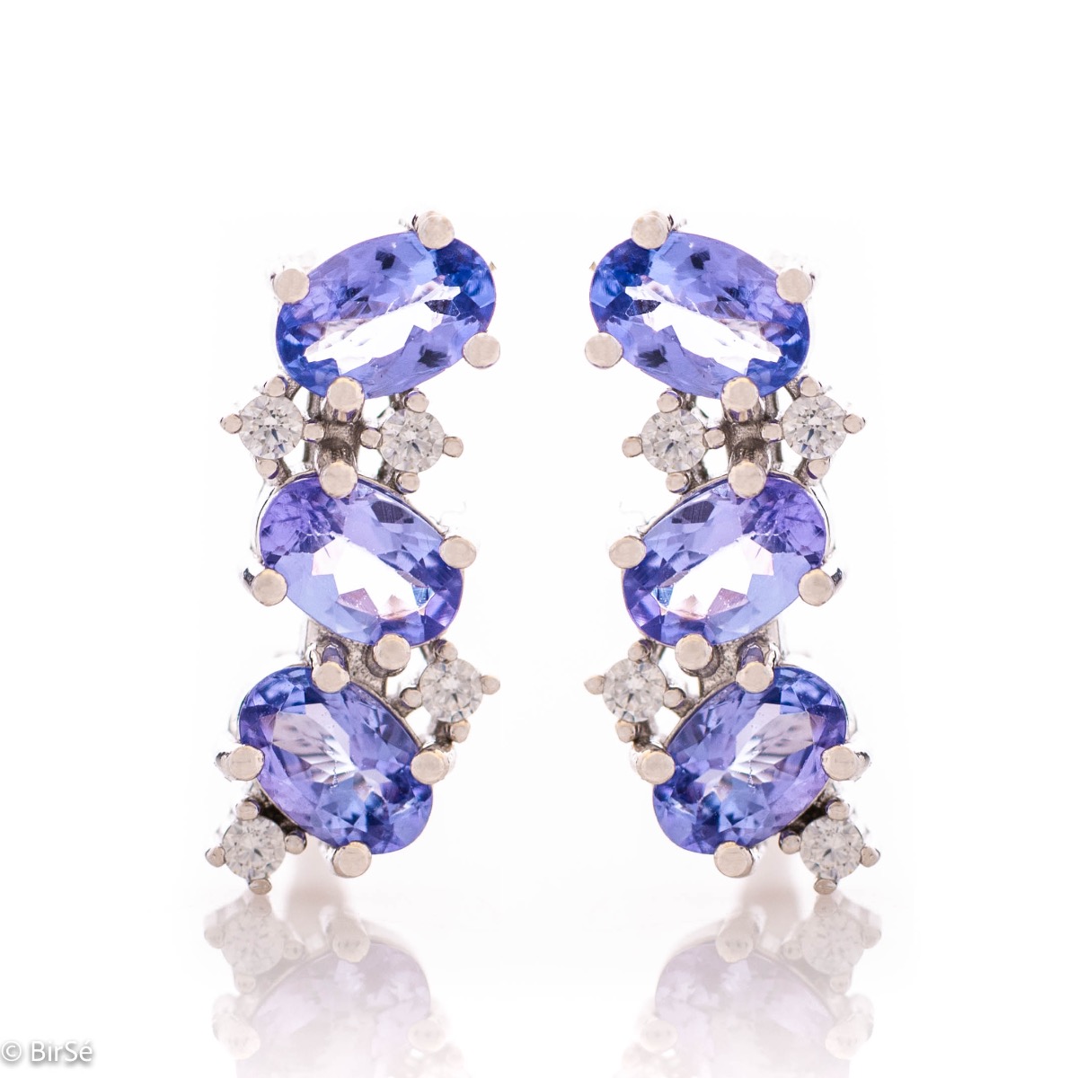 Exquisite English clasp earrings for women, intertwining delicate rhodium-plated sterling silver craftsmanship with radiant natural tanzanite stones. Complete with charm ring.