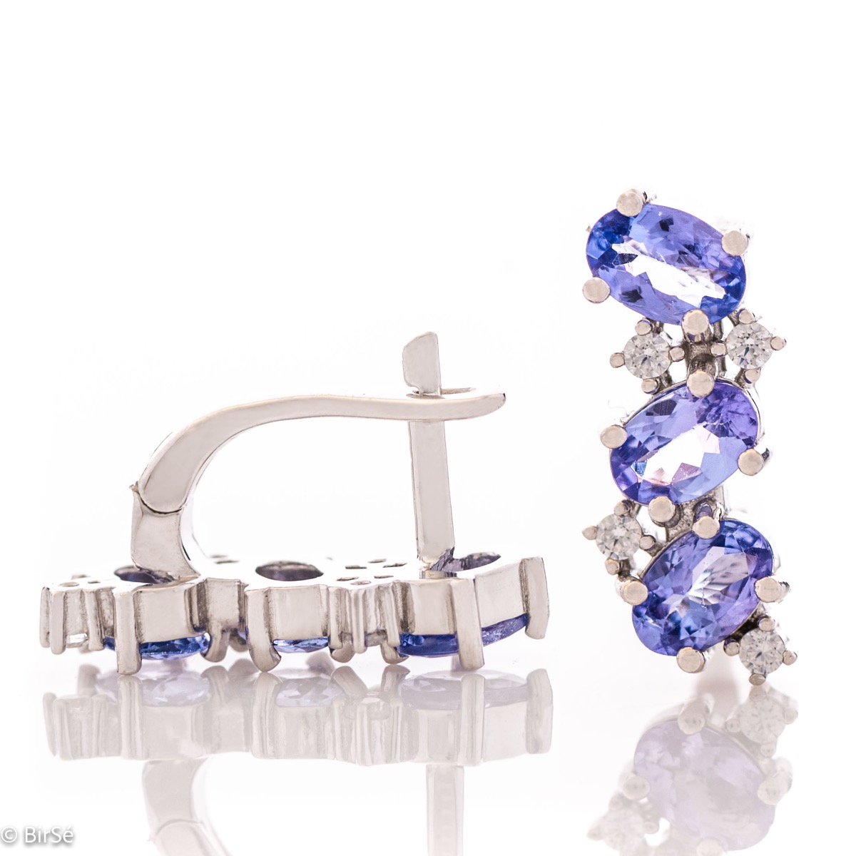 Exquisite English clasp earrings for women, intertwining delicate rhodium-plated sterling silver craftsmanship with radiant natural tanzanite stones. Complete with charm ring.