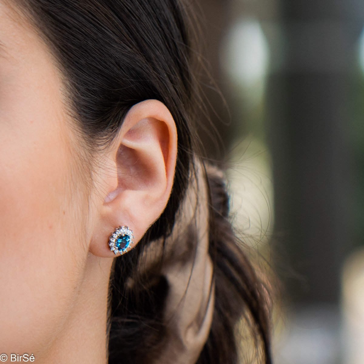 Exquisite women's marquise stud earrings delicately crafted entirely from rhodium-plated silver combined with the glow of a natural London topaz stone surrounded by sparkling zircons.