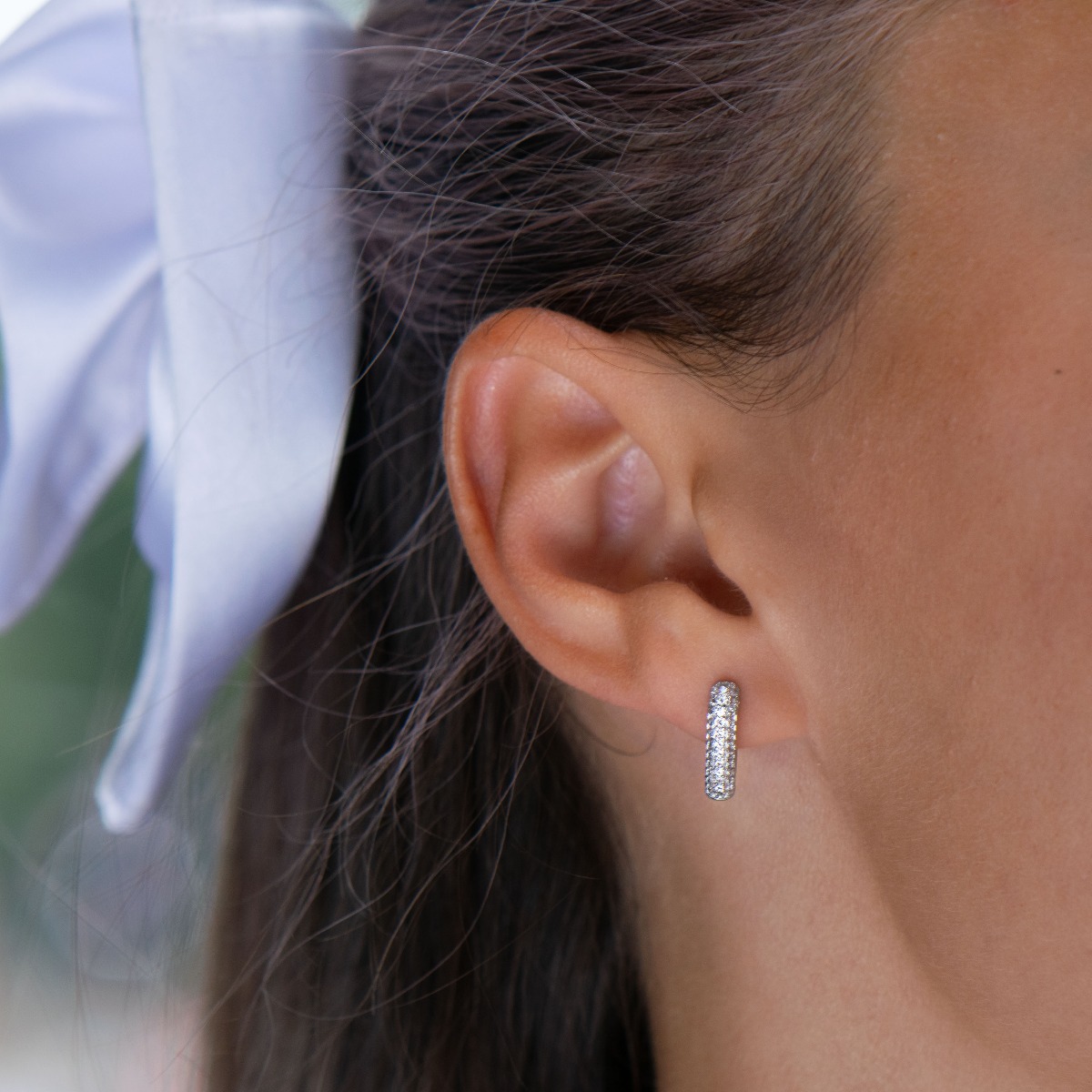 Elegant sterling silver earrings with an English clasp and precision craftsmanship entirely from soft rhodium-plated silver combined with fine, sparkling zircons.