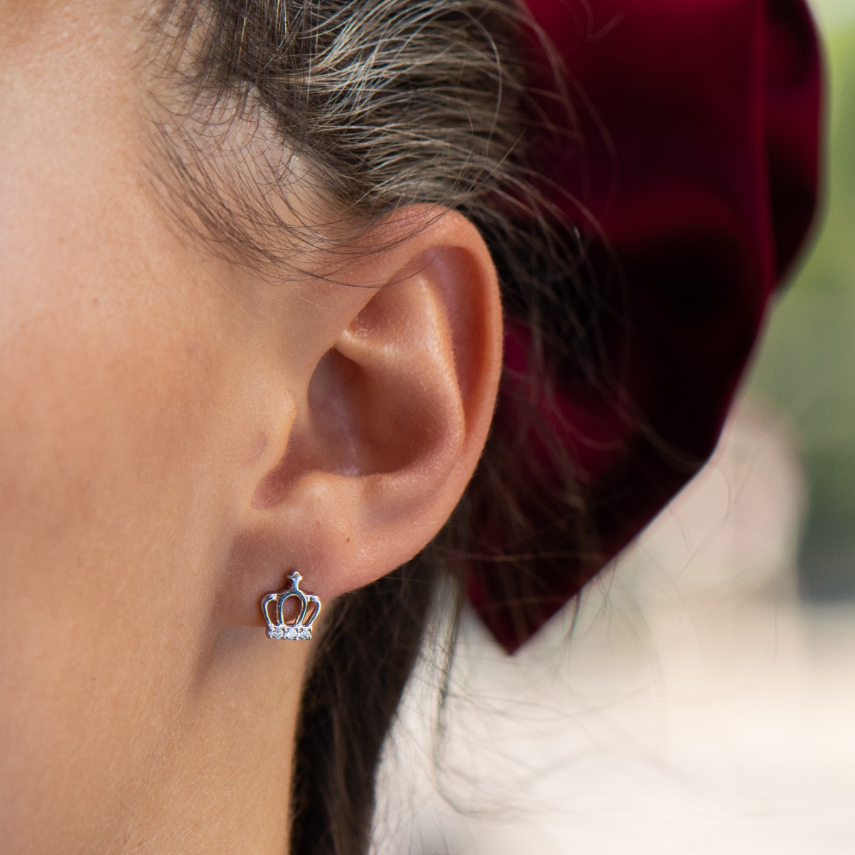 Delicate women's earrings in fine rhodium silver, with elegantly shaped crowns, at the base of which charmingly sparkle zircons. The earrings are fastened with a pin - extremely comfortable and practical. A suitable gift for any princess.