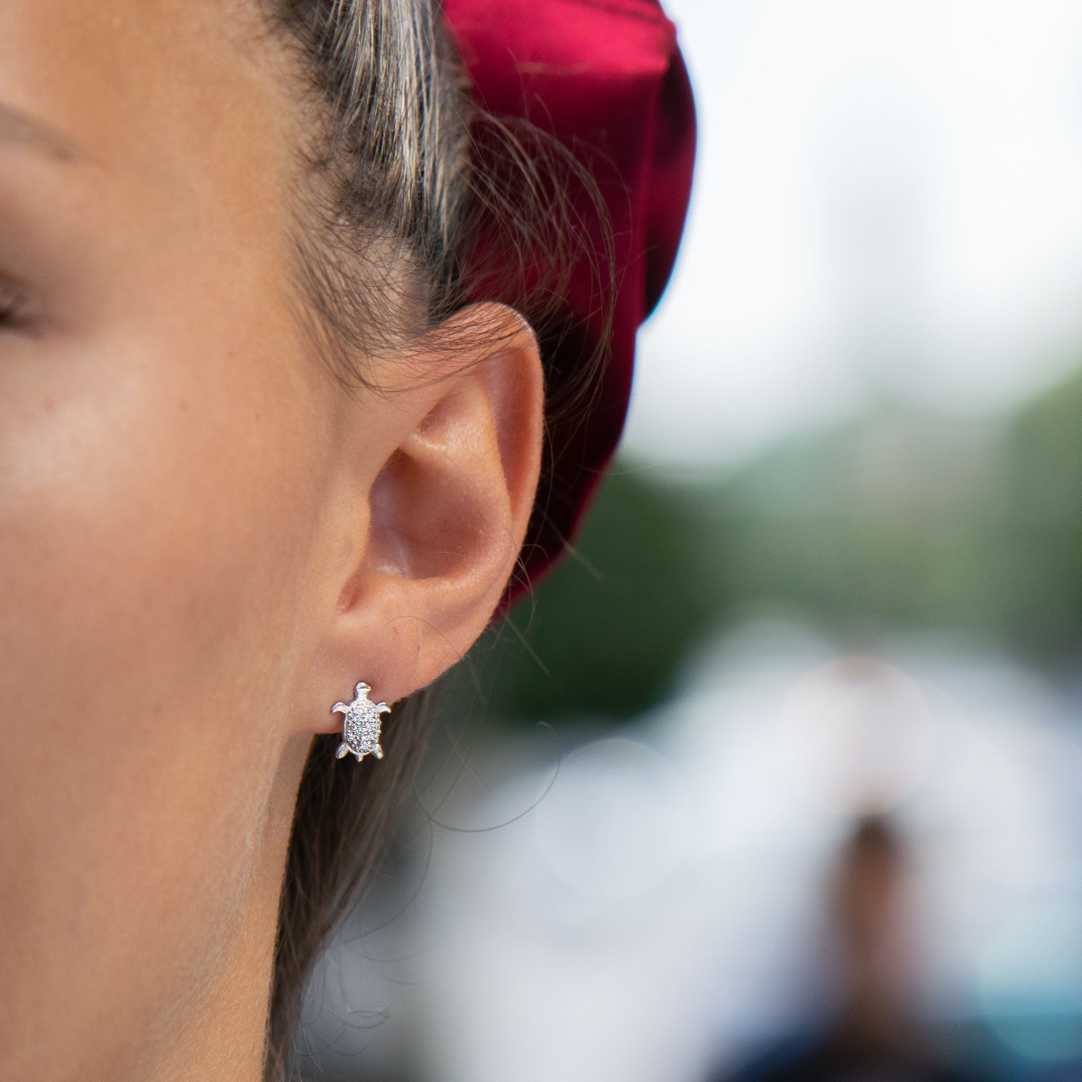 Delicate women's earrings in fine rhodium silver, with designer shaped turtles studded with sparkling zircons. The earrings are fastened with a pin - extremely convenient and secure. A suitable gift for any lady, being a symbol of constancy and wisdom.