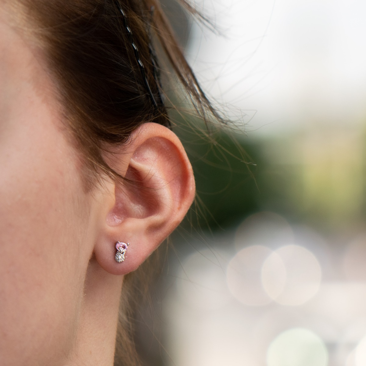 Charming delicate earrings made entirely of rhodium-plated sterling silver that gracefully embrace a beautiful pink stone. Its lovely shine is further enhanced by countless fine zircons. The earrings have a pin fastening and are suitable for both children