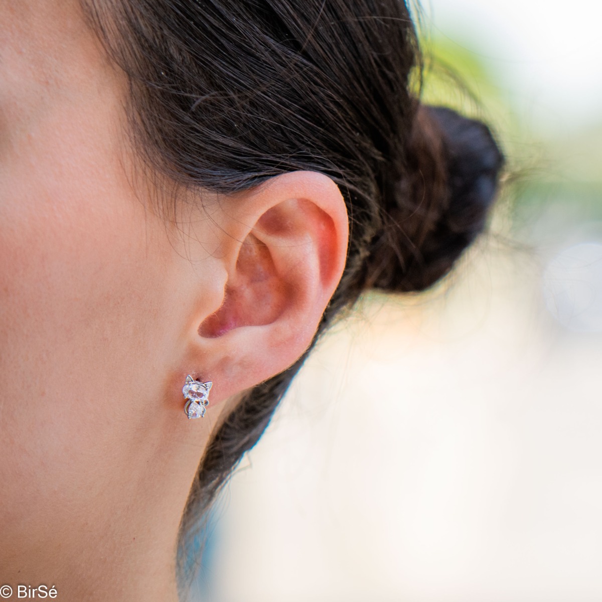 Captivating sterling silver earrings with a charming design of soft silver delicately shaping a kitten figure. The added sparkling zircons only enhance the beauty of the jewelry. Complete with a pendant of the same design.