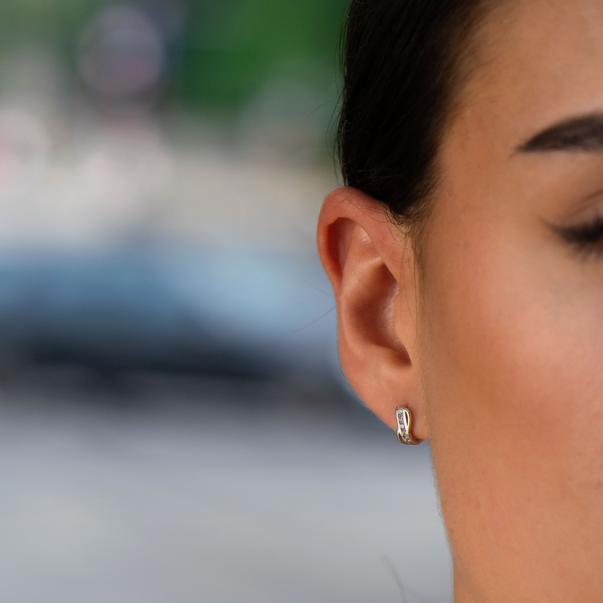 Delicate ladies' earrings made of rhodium-plated silver with a comfortable English clasp. The front side of the earrings is shaped like an exquisite infinity, carefully decorated with zircons.