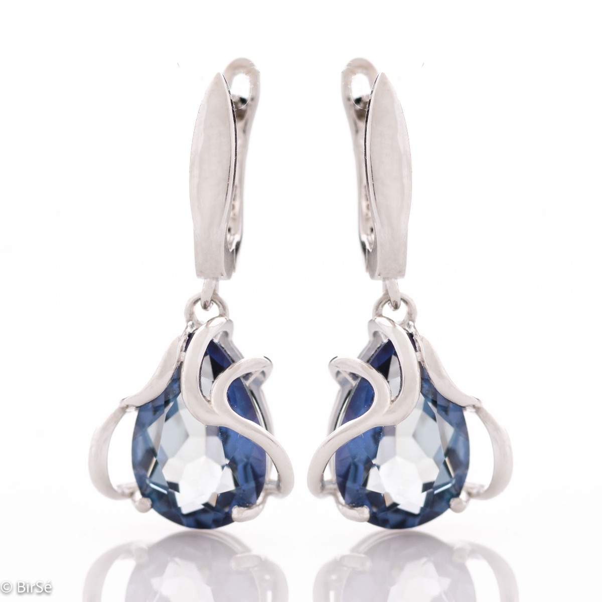 Exquisite earrings with an English clasp and a spectacular combination of soft rhodium silver with a radiant natural blue mystic topaz, enveloped in extraordinary curves.