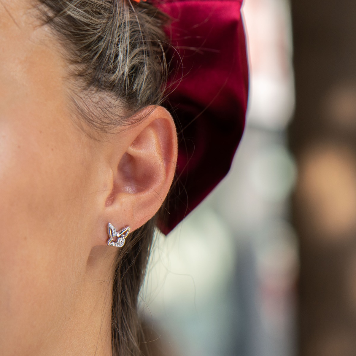 Delicate women's earrings in fine rhodium silver, with an interesting design of a butterfly with added zircons. The earrings are fastened with a pin - extremely convenient and secure. A suitable gift for the girl of your heart.