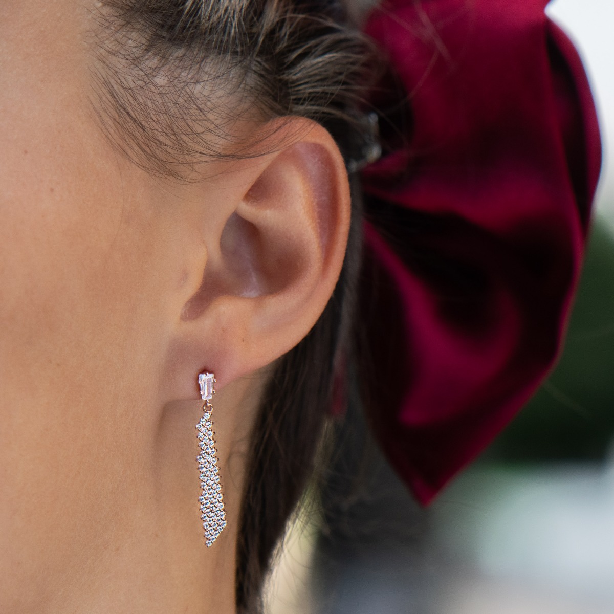 Elegant earrings with a stylish design - a fine network of rose silver, decorated with sparkling zircons. A charming baguette-shaped zircon conceals a pin fastening, favored by ladies as comfortable and practical.