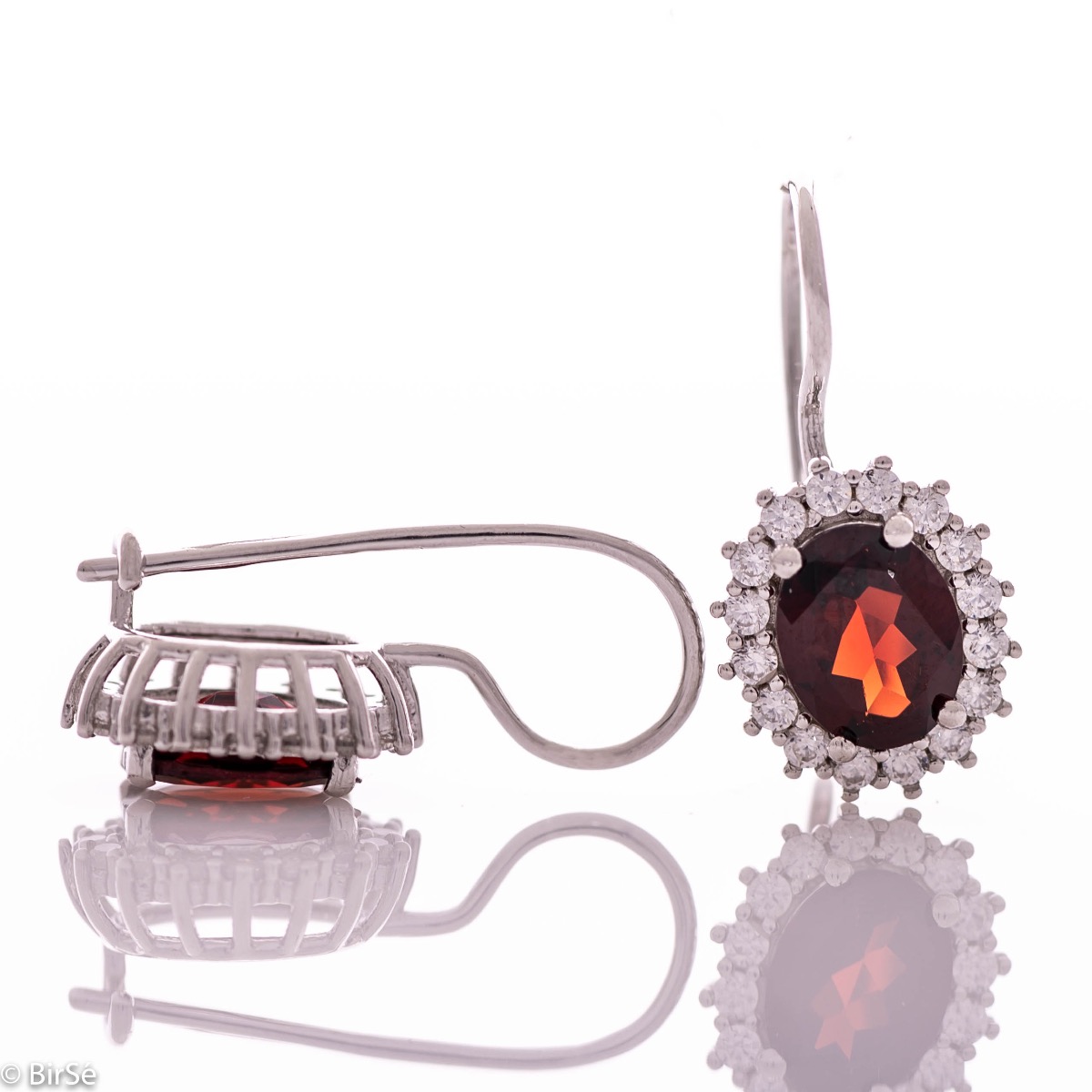 Exclusive women's earrings with exquisite workmanship combining delicate rhodium silver with radiant natural garnet surrounded by sparkling zircons.