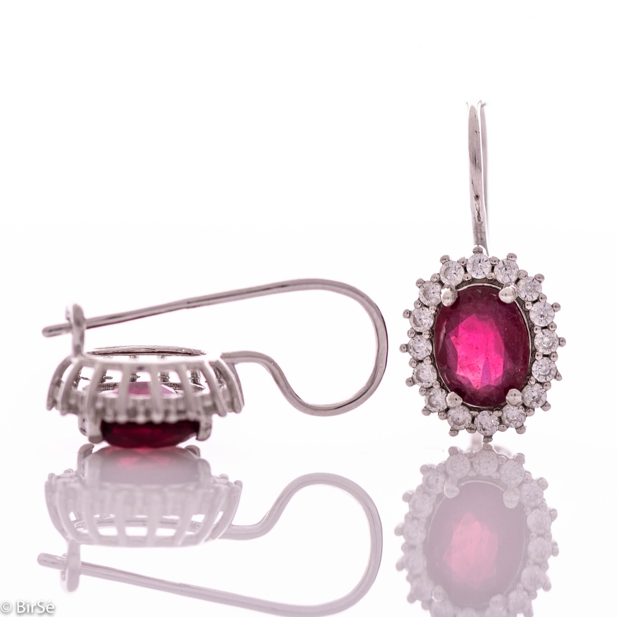 Exclusive women's earrings with exquisite craftsmanship combining delicate rhodium silver with a radiant natural ruby ​​surrounded by sparkling zircons.