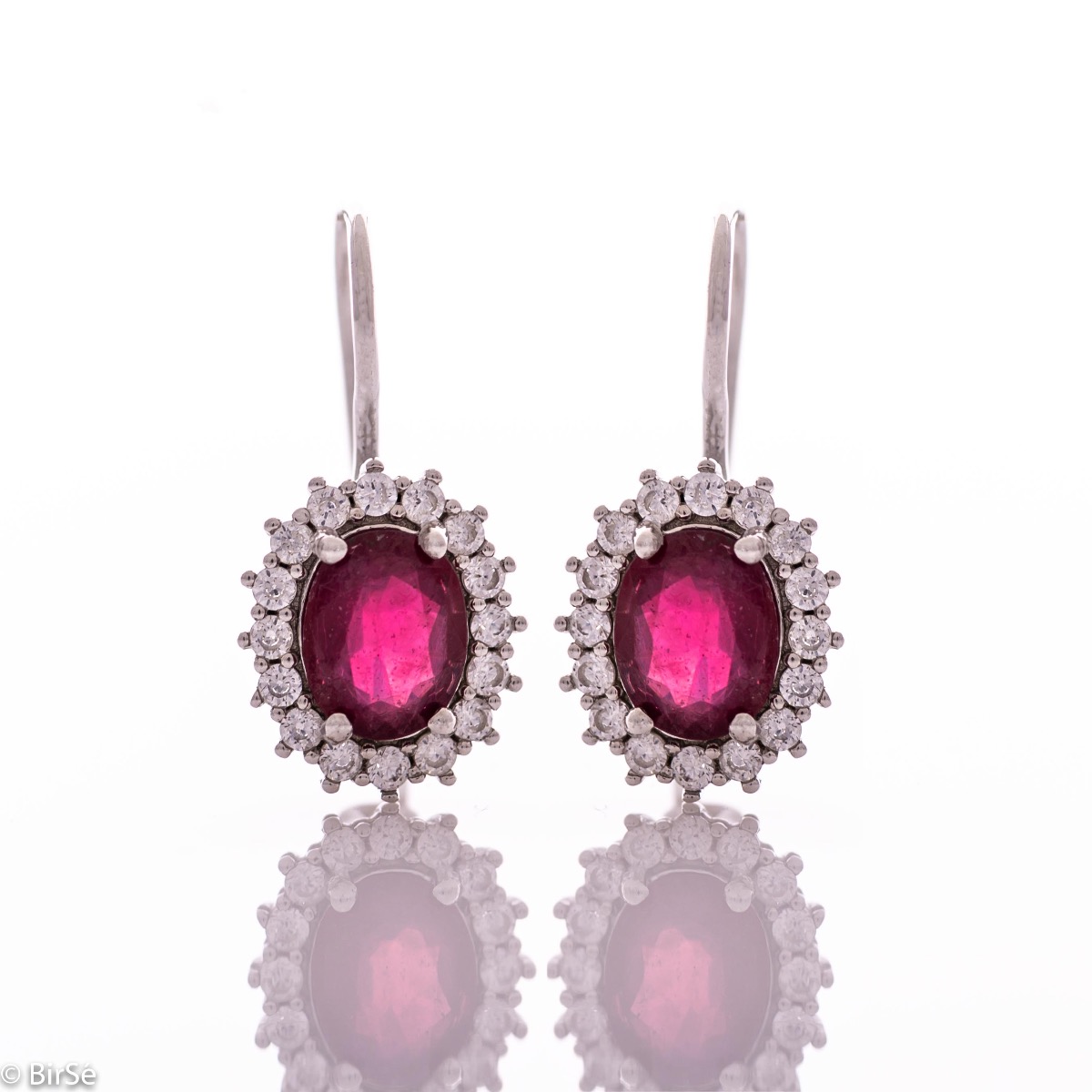 Exclusive women's earrings with exquisite craftsmanship combining delicate rhodium silver with a radiant natural ruby ​​surrounded by sparkling zircons.