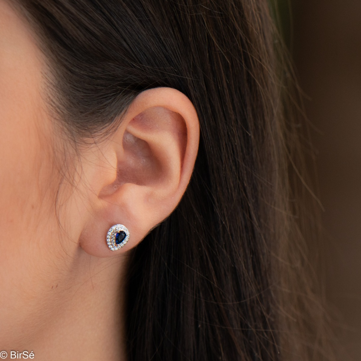 Impressive women's earrings made entirely of rhodium-plated silver with a teardrop shape. In the center, a mesmerizing black cubic zirconia draws the eye with its magical color, while a dazzling double row of cubic zirconias encircling it add a royal char