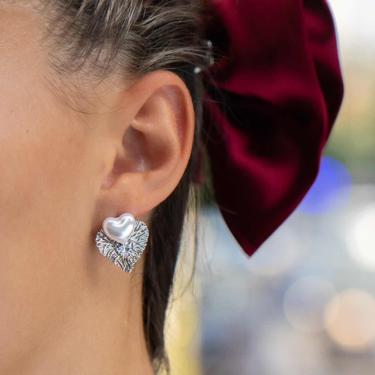 Longing and dreaming of love expressed in the new BirSe earrings. Crafted from fine rhodium silver, an openwork heart gently wraps around a smaller pearl heart and added cubic zirconias for added sparkle. The jewelry is a beautiful gift for the beloved wo