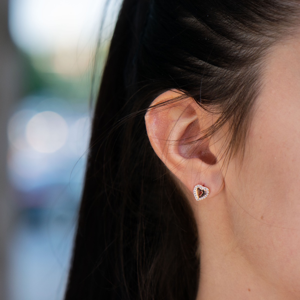 Stylish women's earrings in rhodium-plated rose silver with a heart shape, elegantly decorated along the contour with sparkling zircons.