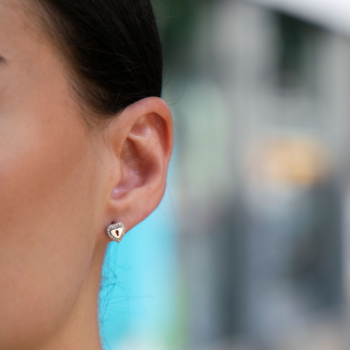 Stylish heart-shaped rhodium silver earrings for women, elegantly decorated along the contour with sparkling zircons.