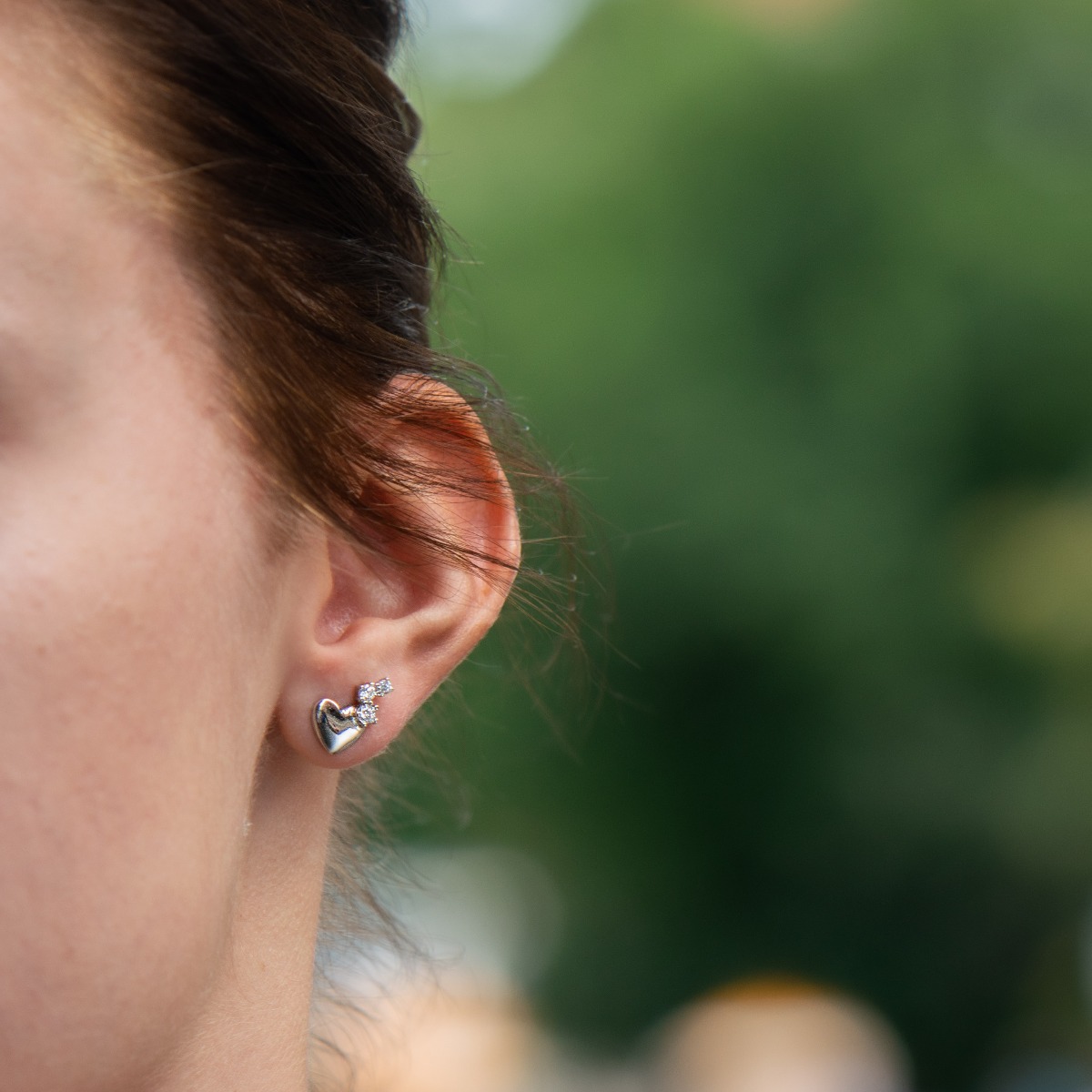 Captivatingly delicate earrings for women, entirely made of fine rhodium-plated silver in the shape of a heart. Tiny zircons are playfully attached to the main element, which add extra charm to the jewelry.