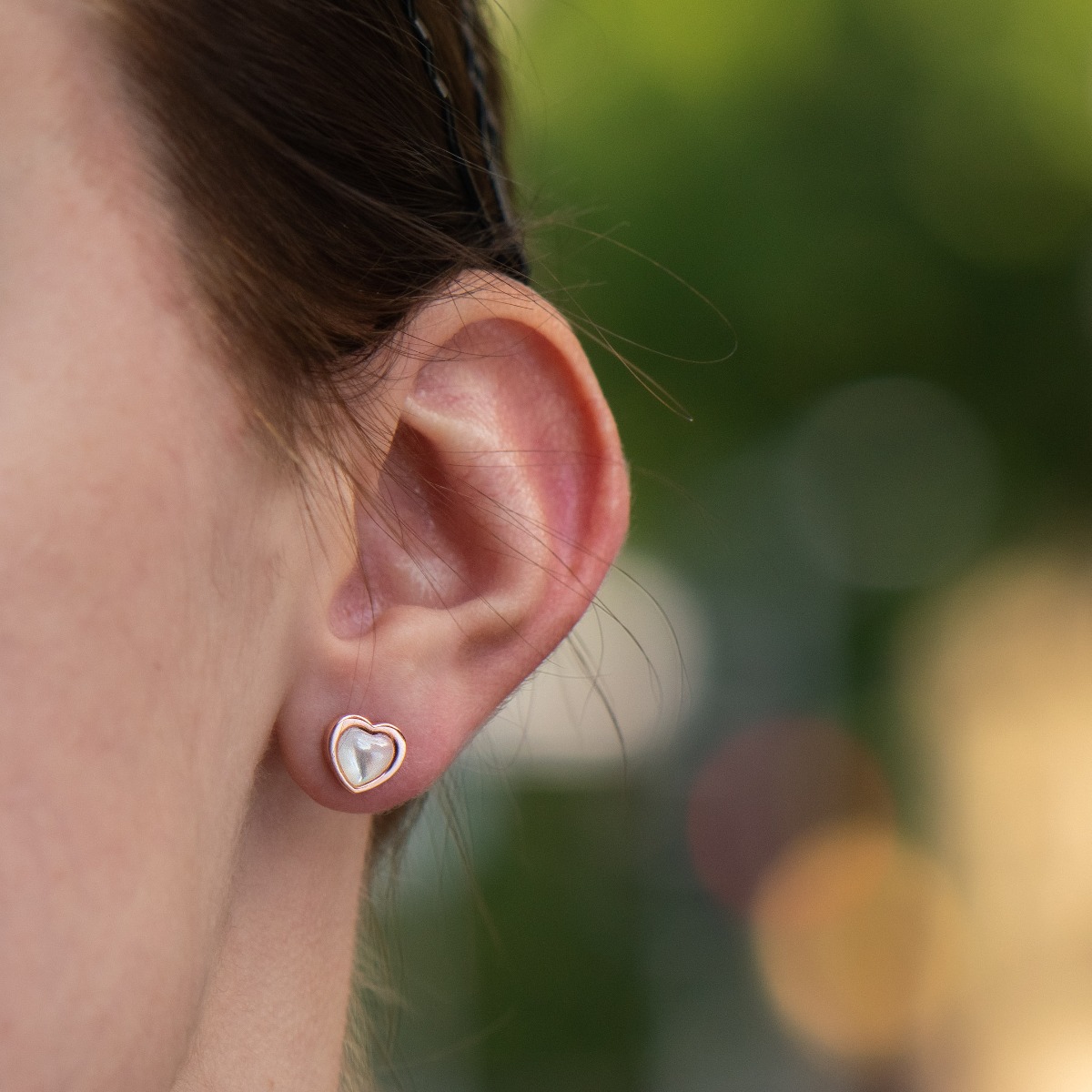 Elegant ladies' earrings made entirely of fine rose silver with a heart shape. Their core is shaped from a beautiful milky white stone, and the fastening is with a pin.