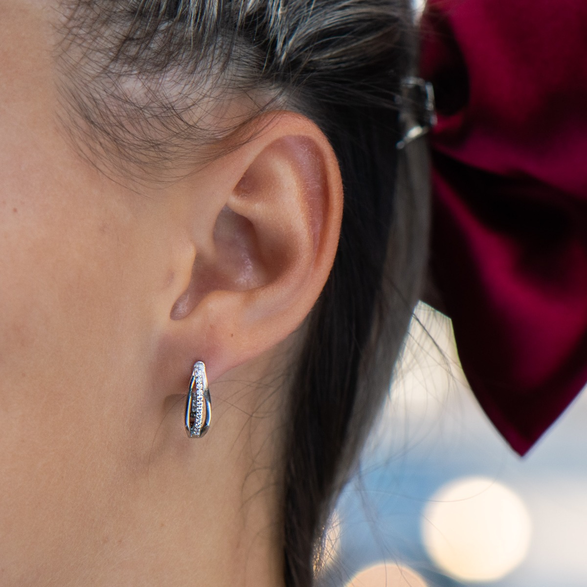 Elegant earrings with a stylish design, fine elements of rhodium-plated silver, decorated with sparkling zircons. The earrings have an English fastening - practical and secure.