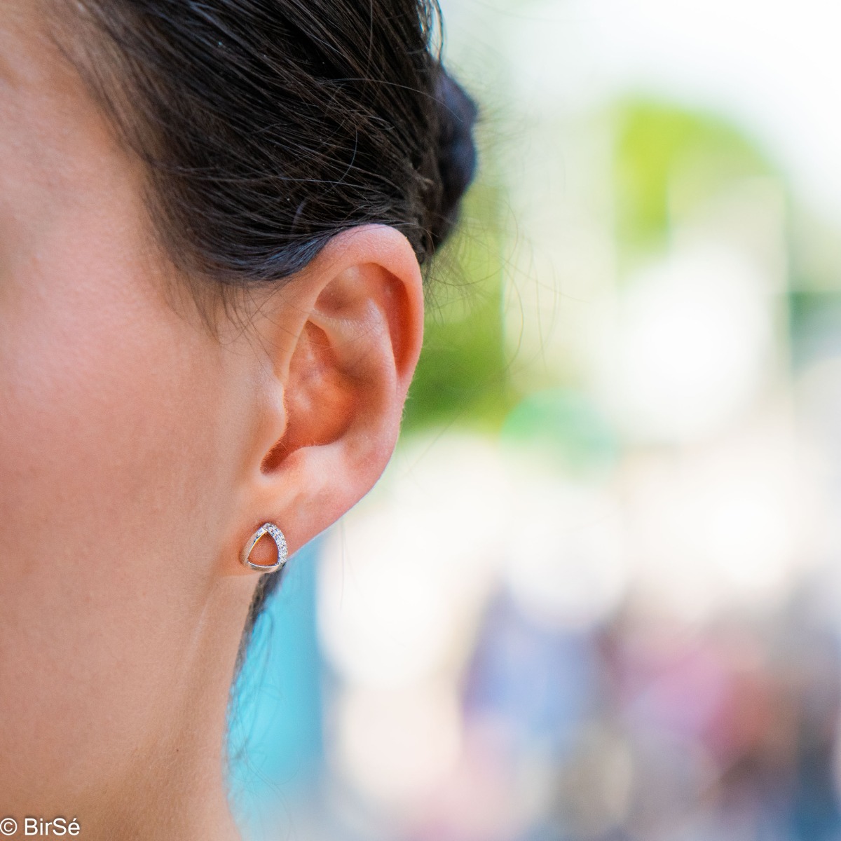 Charming earrings with a delicate design, made of rhodium-plated silver, combined with fine sparkling zircons. The pin fastening is secure and comfortable, and the earrings make a suitable gift for any lady.