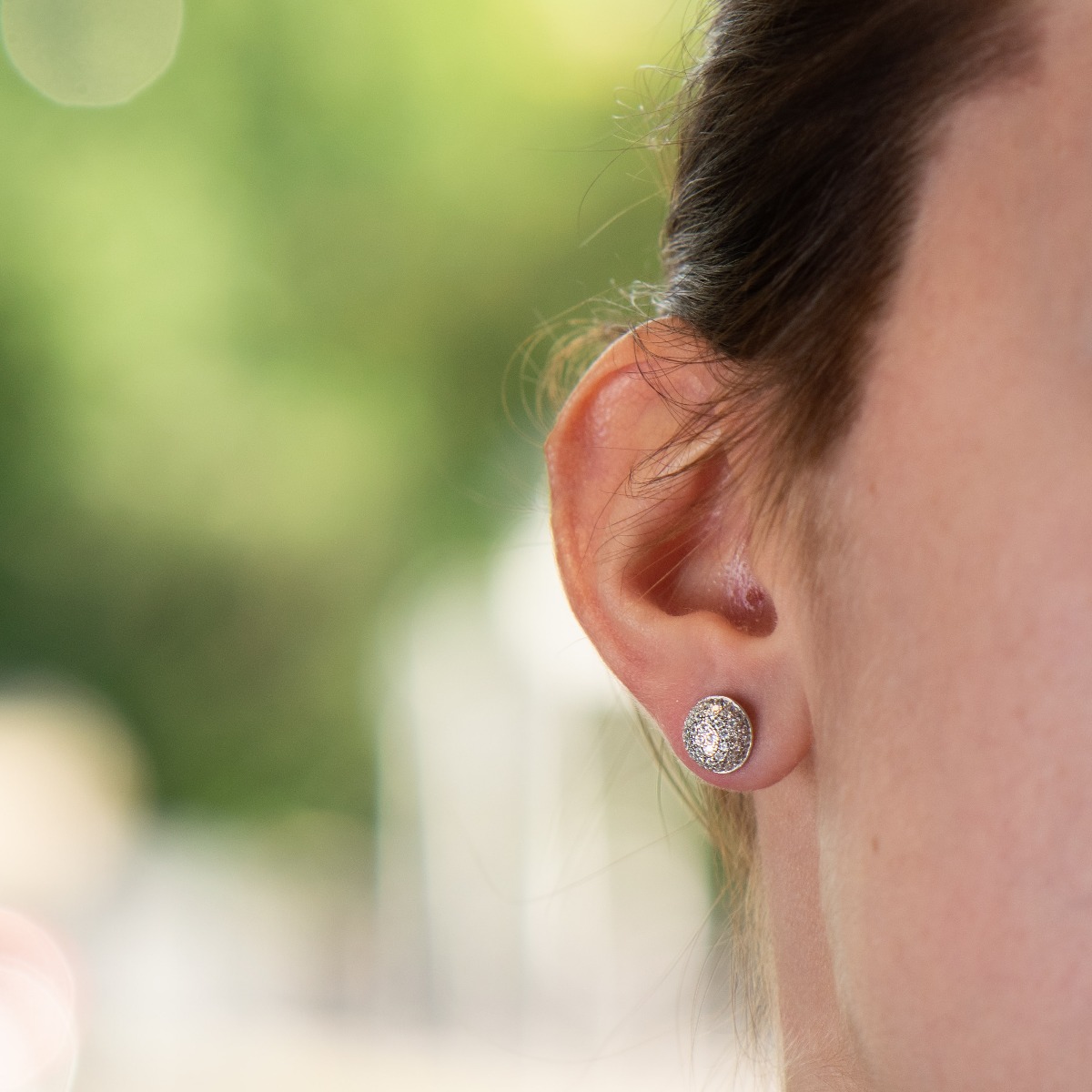 Charming women's earrings, masterfully crafted from fine rhodium silver with an elegant design. A beautifully sculpted hemisphere, dazzling zircons magically sparkle on silver, and the pin fastening is comfortable and practical.