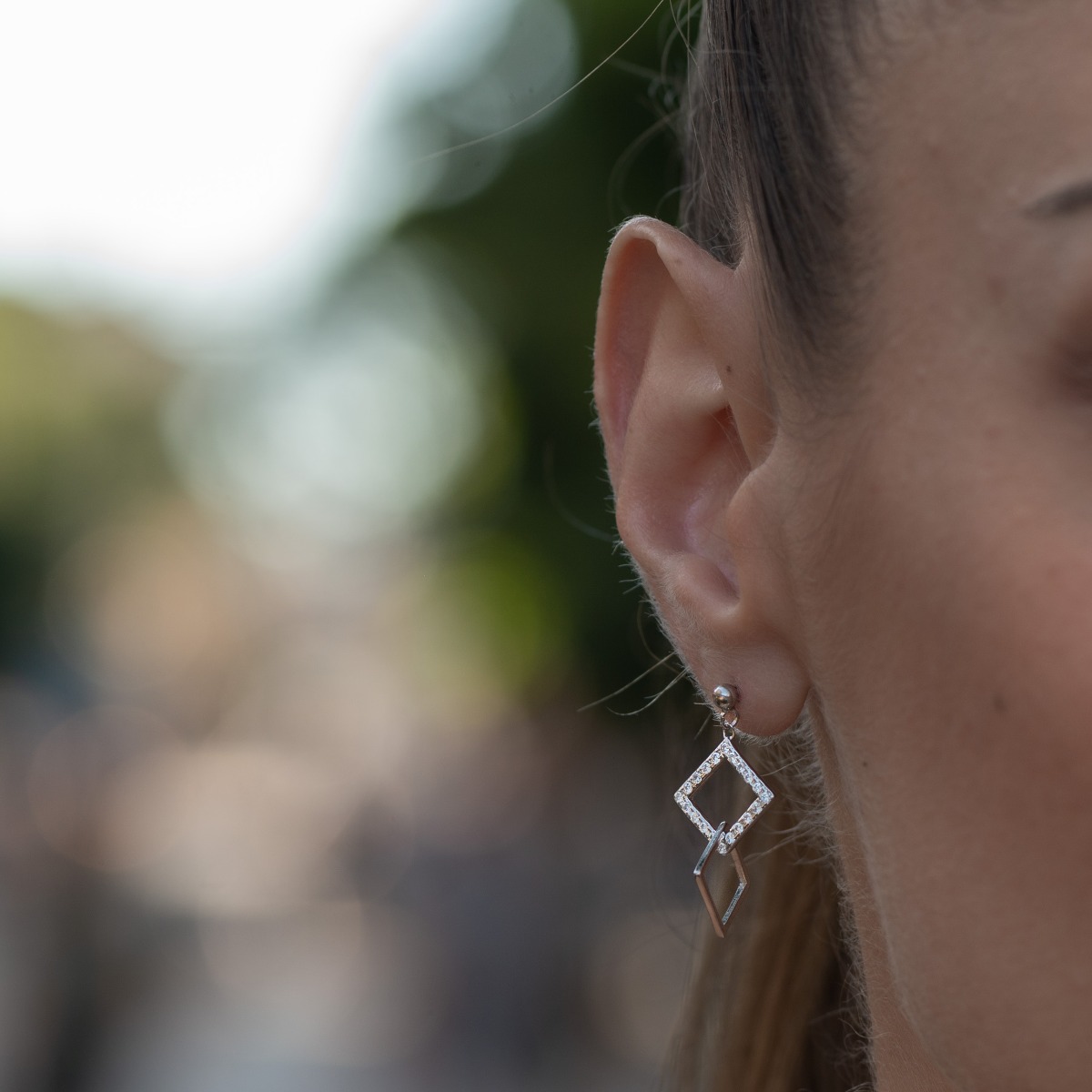 Delicately elegant silver earrings with a dangling shape and pin fastening. Stylish craftsmanship from a fine combination of rhodium-plated silver with sparkling zircons. Rhombus-shaped hanging elements and chic design are a guarantee of a great mood.