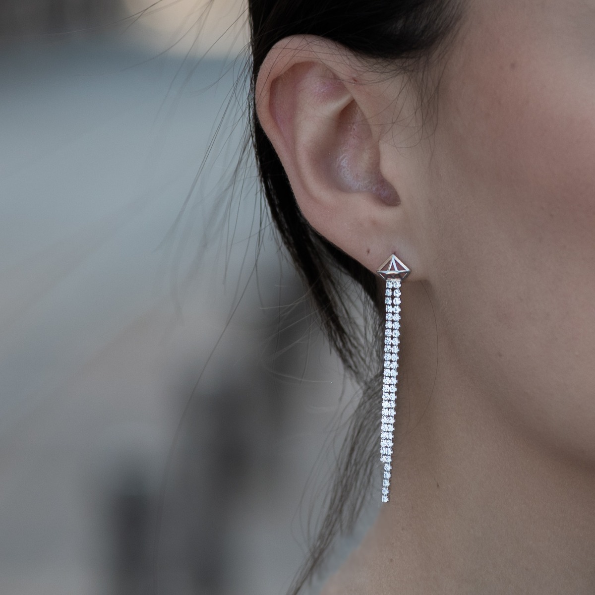 Charming women's earrings, elegantly formed by two delicate silver chains, completely covered with sparkling zircons. The earrings are fastened with a pin, for greater convenience and security.