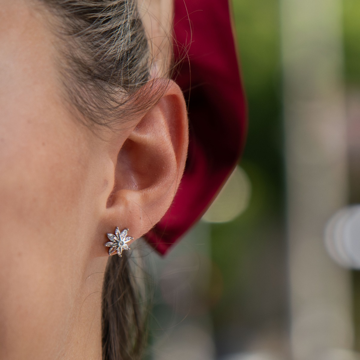 Delicate women's earrings made of fine rhodium silver, with an interesting design layout of a charming flower. Beautiful petals, exquisitely decorated with glittering zircons of different shapes, make this jewelry a suitable gift for any lady. And the pin