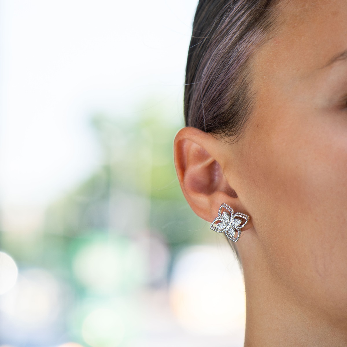 Enchanting Flowers Silver Earrings - an exquisite piece of jewelry made entirely of fine, sparkling silver. Five dazzling zircons are elegantly caught by strands of rhodium silver, forming a flower. The earrings have a convenient pin fastening and are sui