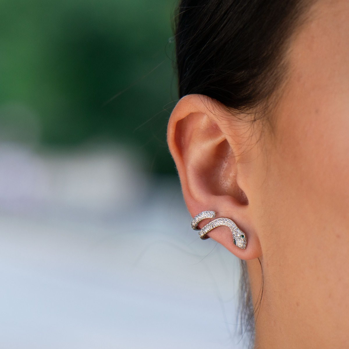 Exotic - extravagant women's earrings in the shape of a snake. Made entirely of rhodium-plated silver, with a comfortable pin fastening and covered with sparkling zircons.