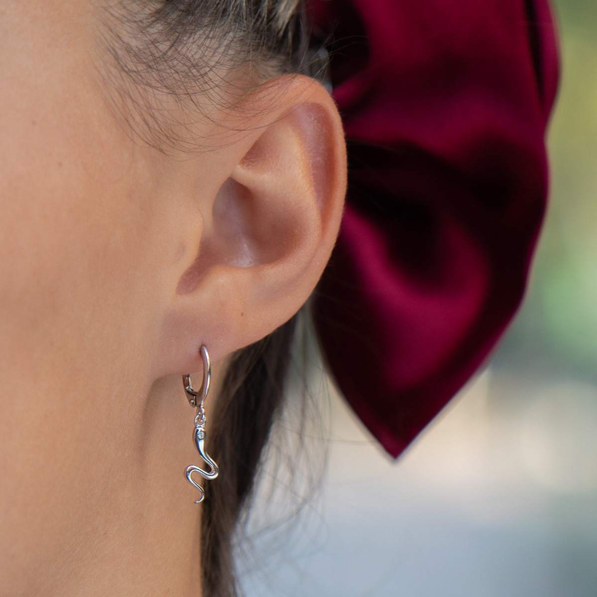 Delicate, airy and light earrings, made with a playful design of fine rhodium-plated silver small snakes. Suitable for ladies with a sense of humor.