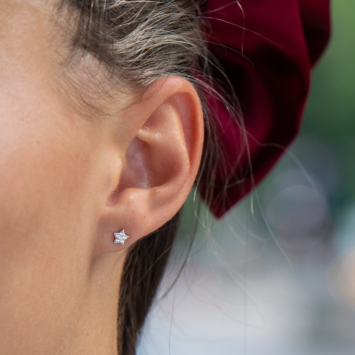 Charming women's star earrings, masterfully crafted from fine rhodium silver with an elegant design. The elements are beautifully sculpted, dazzling zircons magically sparkle, and the pin fastening is comfortable and practical.