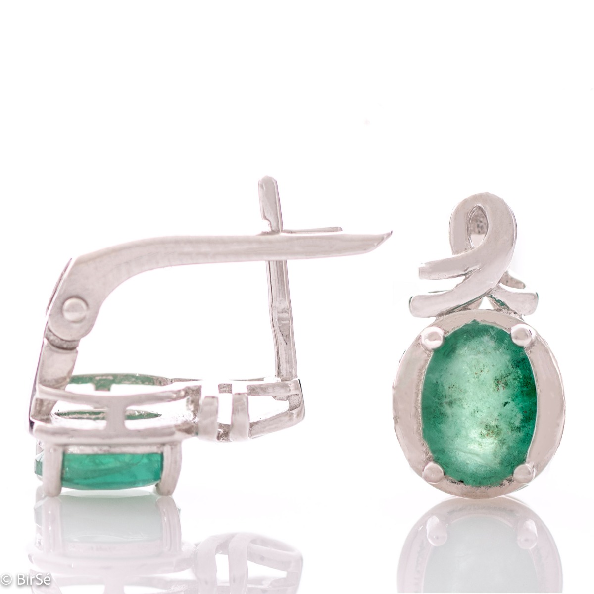 A radiant combination of a unique natural emerald with fine rhodium silver in the elegant women's earrings from BirSe.