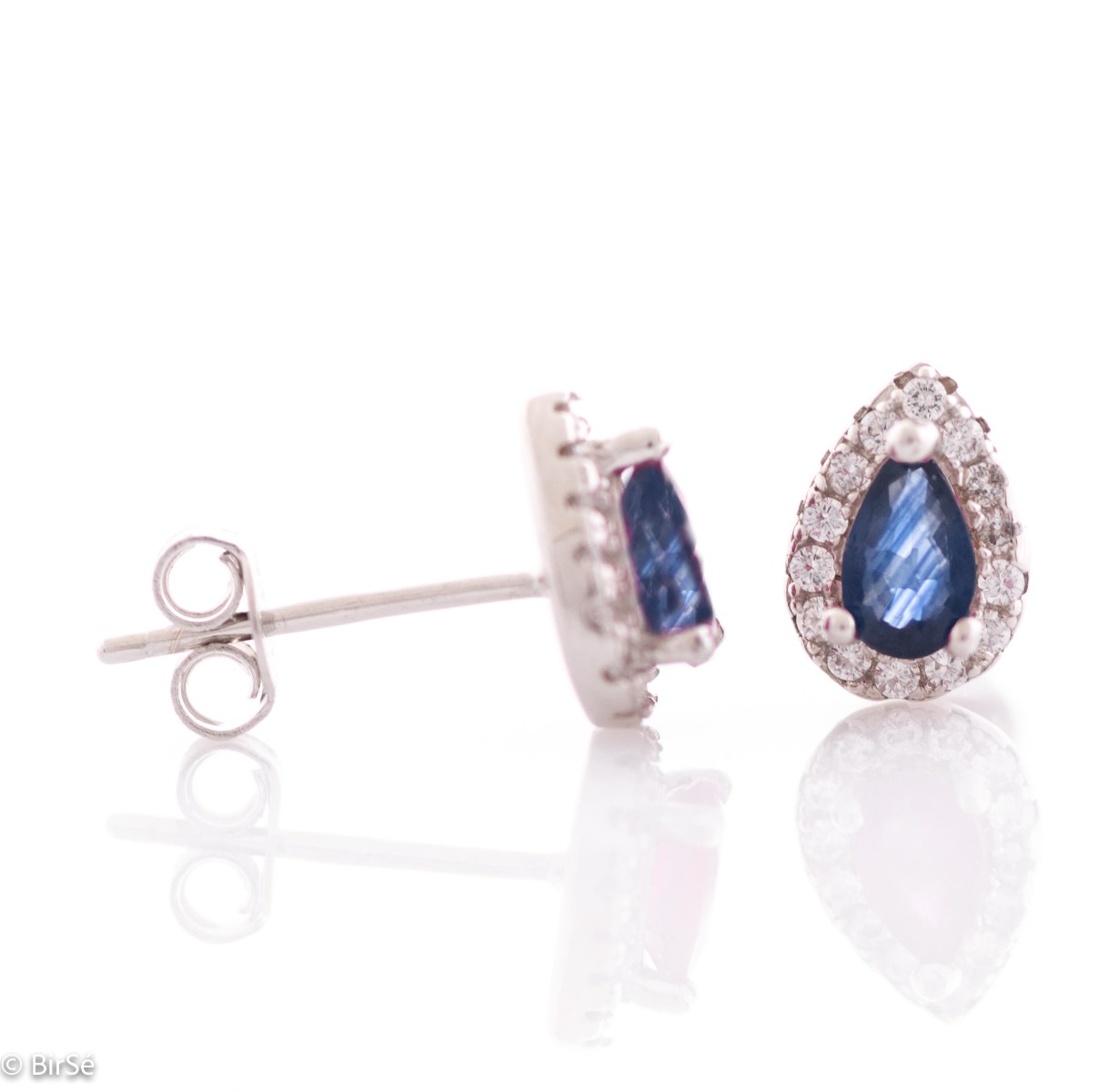 Elegant women's stud earrings with a delicate drop-shaped natural sapphire, surrounded by sparkling zircons and exquisitely crafted in beautiful rhodium-plated silver. In a charming ring, necklace and bracelet set.