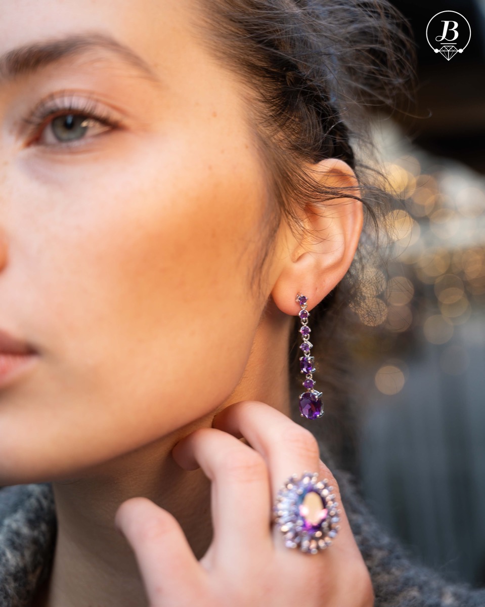 Radiant and spectacular dangling stud earrings with multi-faceted and variously shaped natural amethyst stones and delicately crafted from fine rhodium silver.