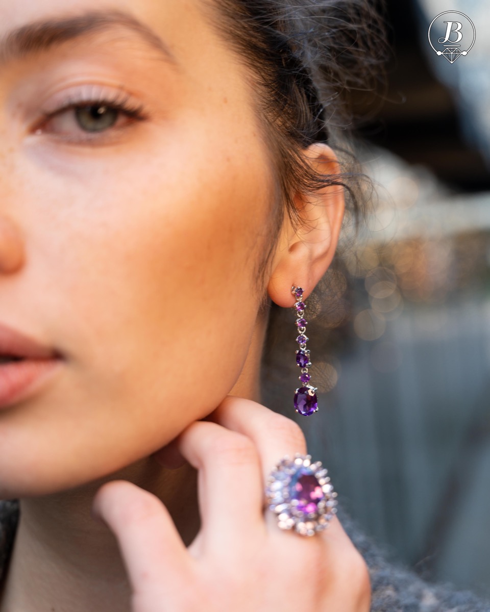 Radiant and spectacular dangling stud earrings with multi-faceted and variously shaped natural amethyst stones and delicately crafted from fine rhodium silver.