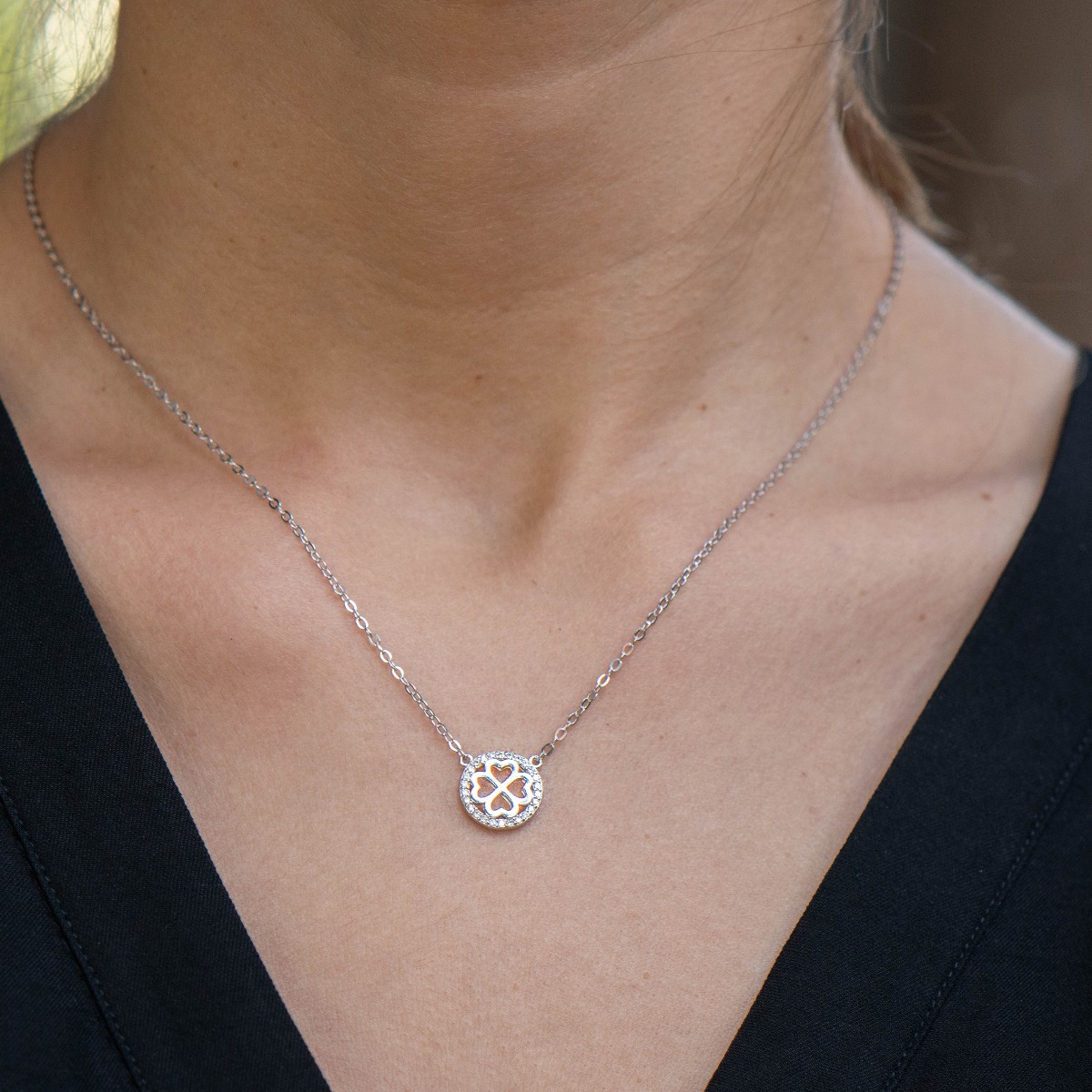 An exquisitely shaped necklace of shiny rhodium silver circle, with a beautiful four-leaf clover inside.