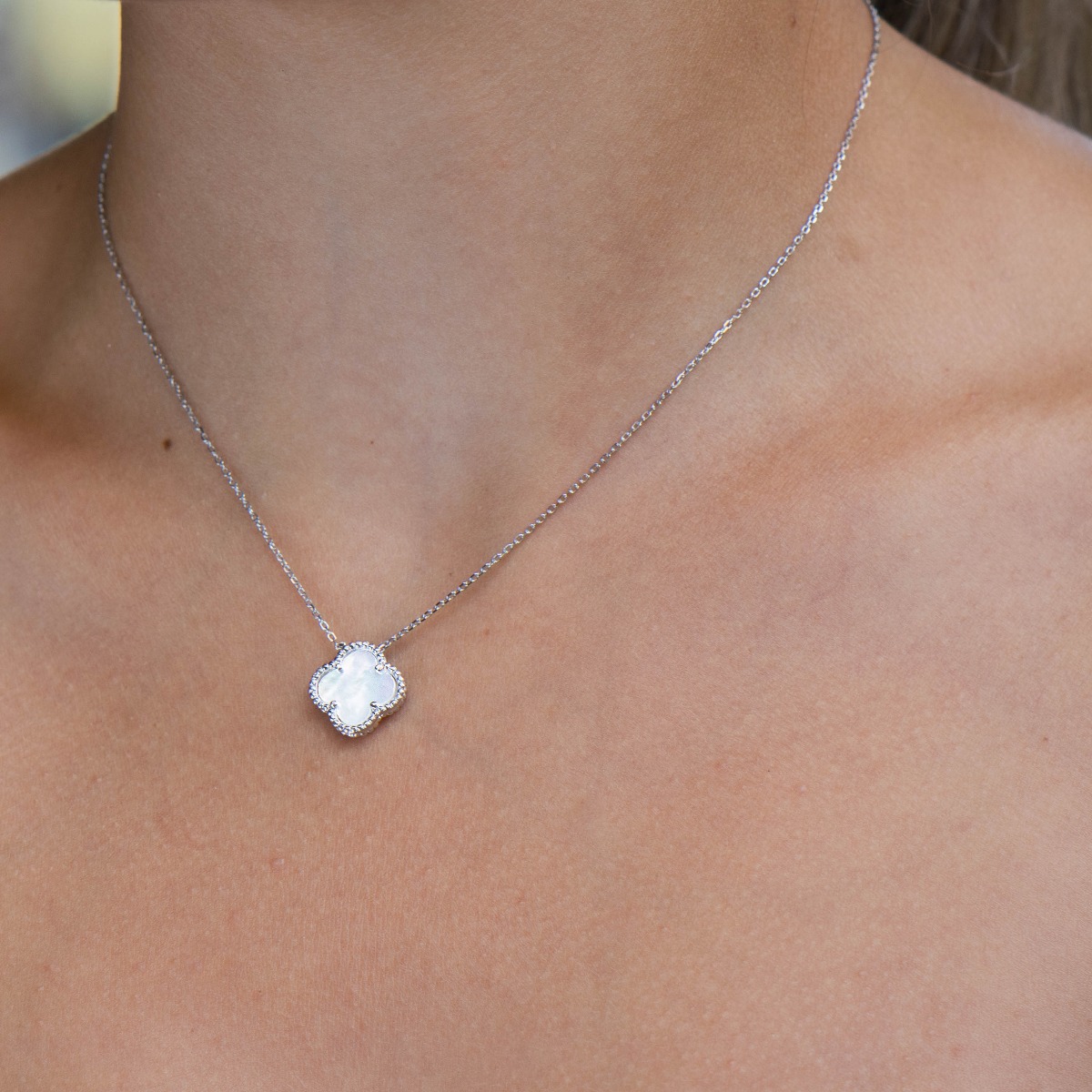 Fine silver Van Cleef model necklace. A beautifully crafted piece of rhodium-plated silver, gently envelops a fine mother-of-pearl in the shape of a four-leaf clover. The chain is delicate, with an extender to be worn according to the lady's preference.