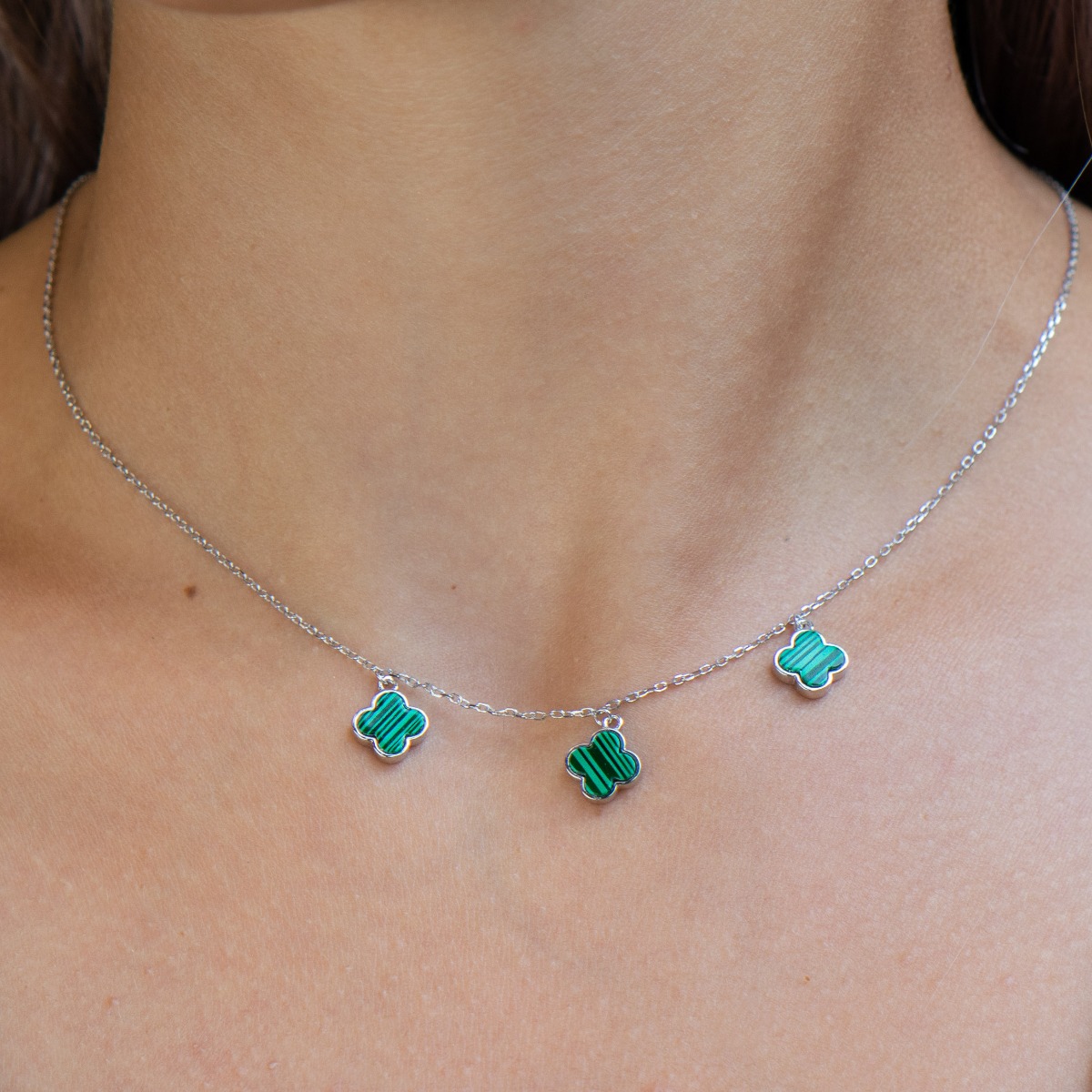 Exquisitely crafted women's necklace of fine rhodium silver, with beautifully shaped pendants - shamrocks of magnetic malachite.