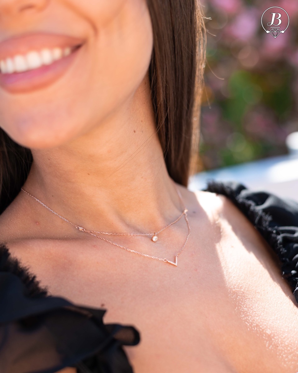 Extremely delicate and elegant women's necklace with a double chain and exquisite elements. Precise workmanship combining rhodium-plated rose silver with fine zircons.