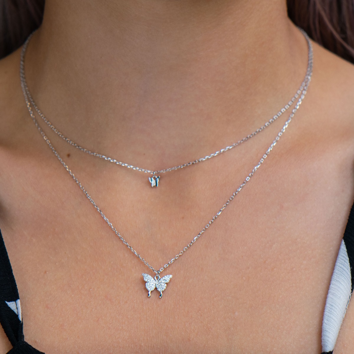 Tempting creation of women's necklace from fine rhodium silver with delicate butterflies and countless glittering zircons. The dainty butterflies are set on two rows of rhodium-plated sterling silver chains, and the extra extension allows for length adjus