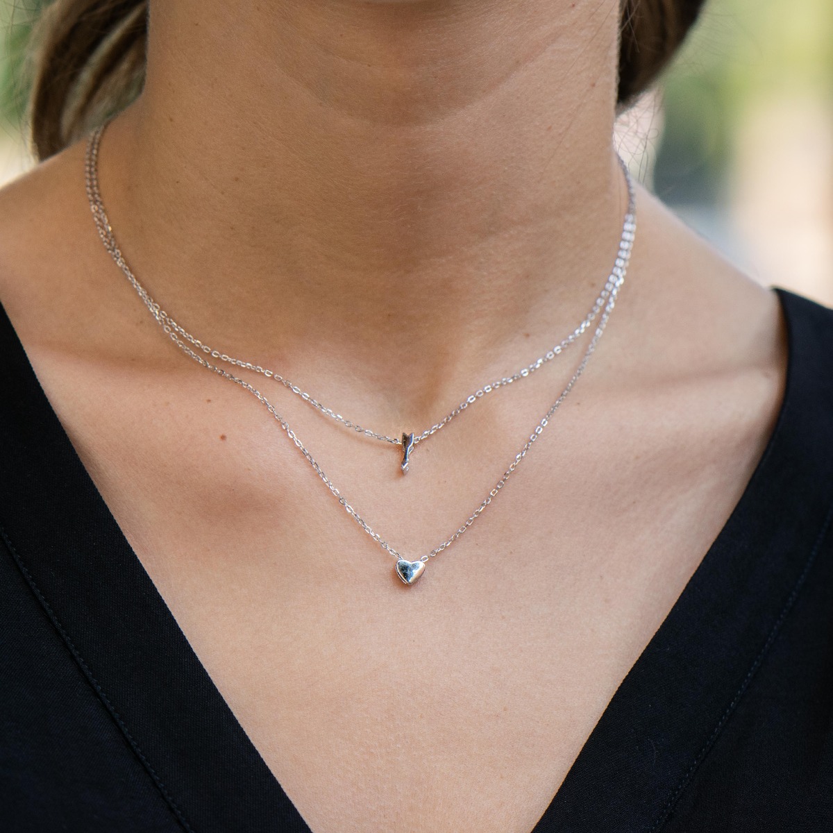 Double sterling silver necklace with two delicate heart and arrow elements and exquisite workmanship entirely in lustrous rhodium silver.