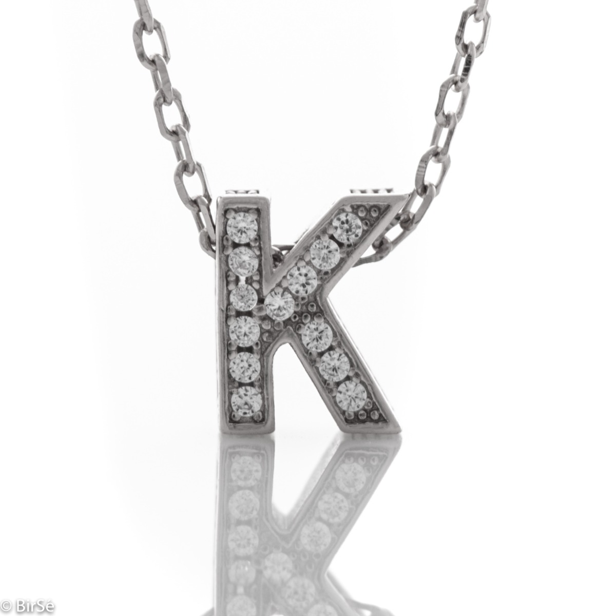 Finely crafted silver letter K necklace for women, all encrusted with glittering zircons. An attractive piece of jewelry in which the delicate beauty of rhodium-plated silver is skilfully combined with the brilliance of zircons.