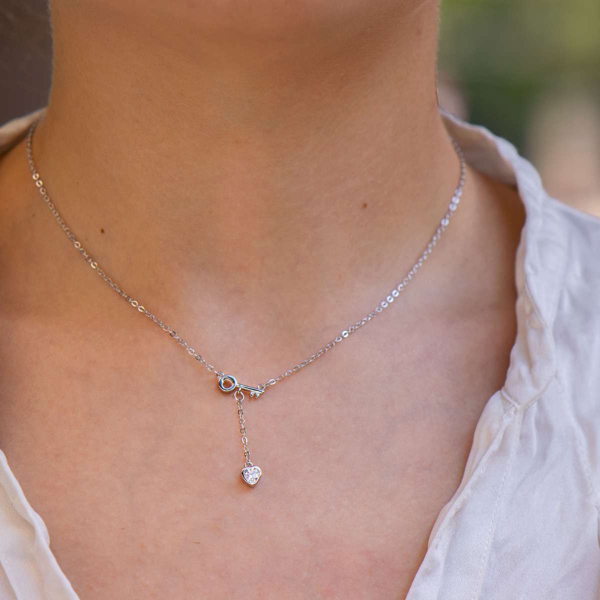 Elegant silver message necklace. A dainty rhodium-plated chain is attached to a dainty key with a cubic zirconia heart hanging below. Discover the key to the heart of the beloved woman with the charming necklace from BirSe.