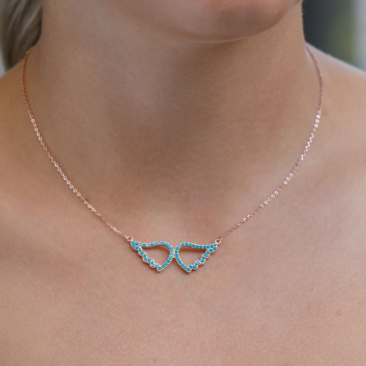 Delicate silver necklace with angel wings, spectacularly decorated with turquoise. Beautiful jewelry for blue-eyed ladies with gentle, angelic souls.