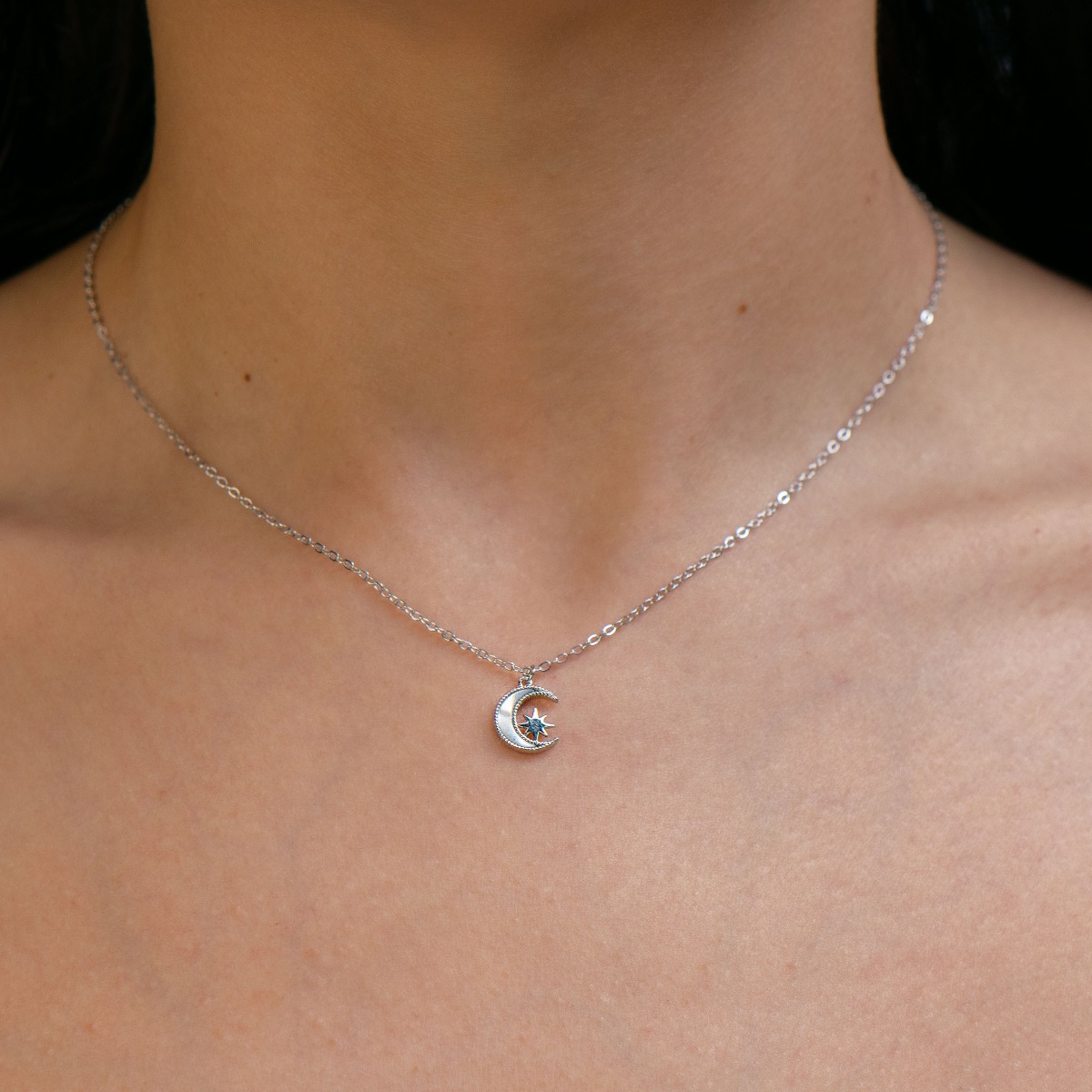 Elegant women's necklace with an exquisite design of rhodium-plated silver. The jewelry is of unique craftsmanship - a gentle moon, charmingly shining in the company of a glittering star.