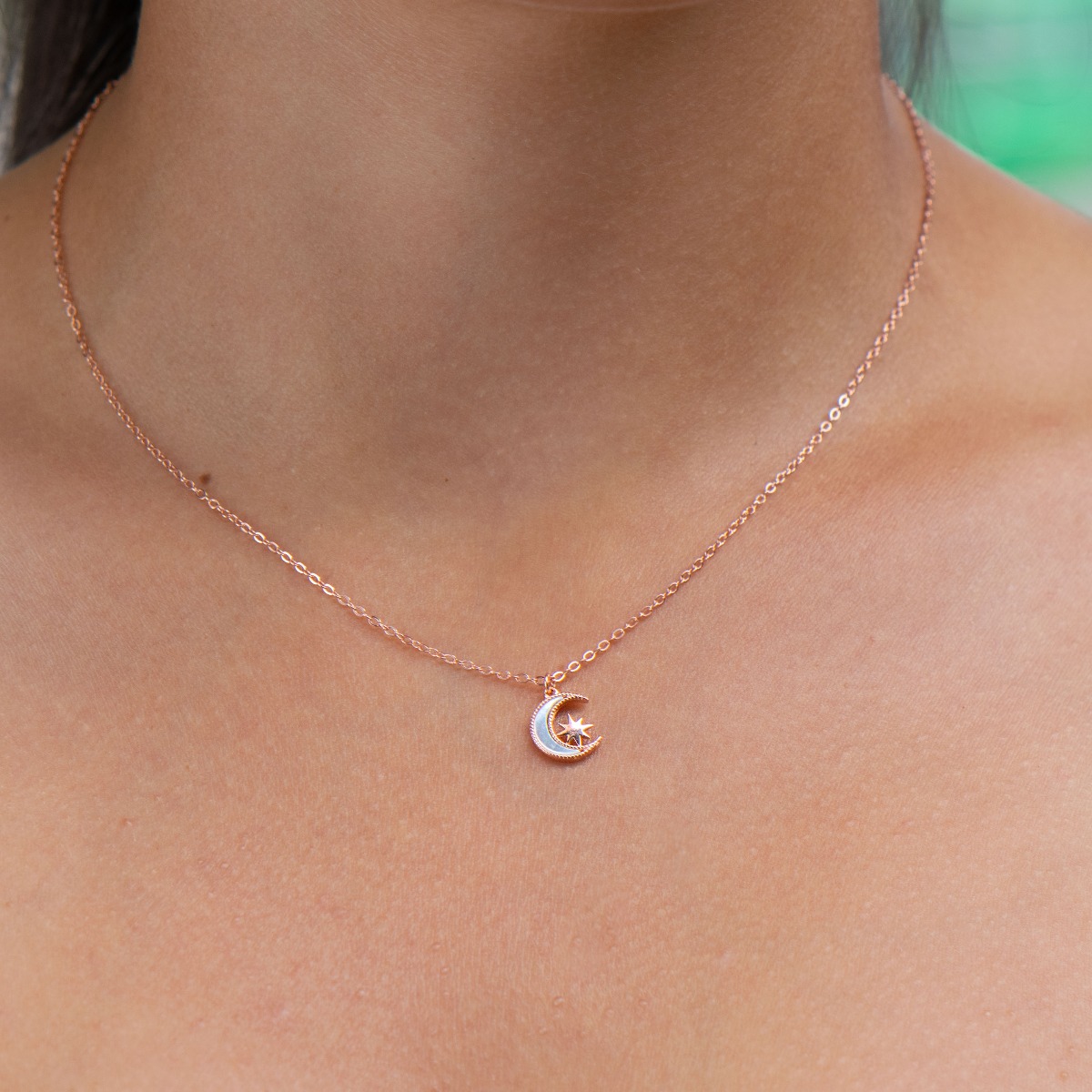 Elegant women's necklace with an exquisite design in rose silver. The jewelry is of unique craftsmanship - a gentle moon, charmingly shining in the company of a glittering star.