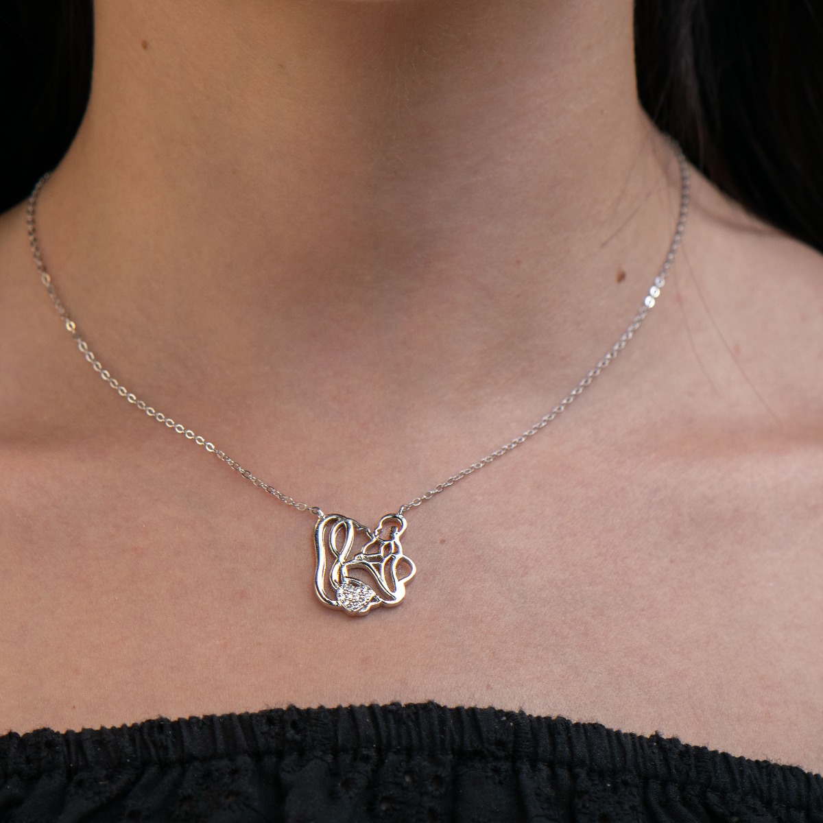 Silver necklace - "Mom and Baby" is an exquisite piece of jewelry, made with a lot of love and craftsmanship from beautiful rhodium-plated silver. A heart fully decorated with zircons gives the necklace extra sparkle. A suitable gift for mothers-to-be or 